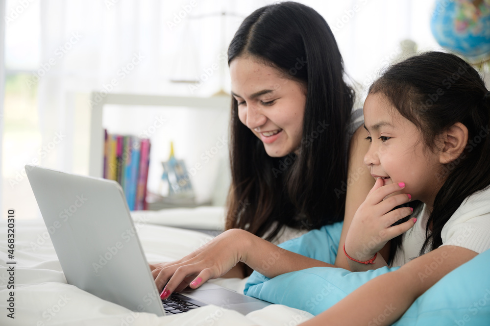 education at home, young mother and child family learning to work a homework with laptop education at home, young mother and child family learning to work a homework with laptop