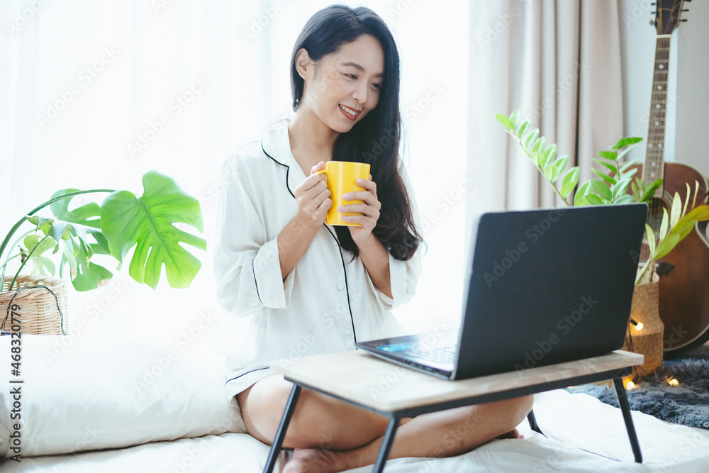 young Asian woman using laptop computer to business online work, female freelance working from home by using internet cyberspace communication technology for businesswoman job young Asian woman using laptop computer to business online work, female freelance working from home by using internet cyberspace communication technology for businesswoman job