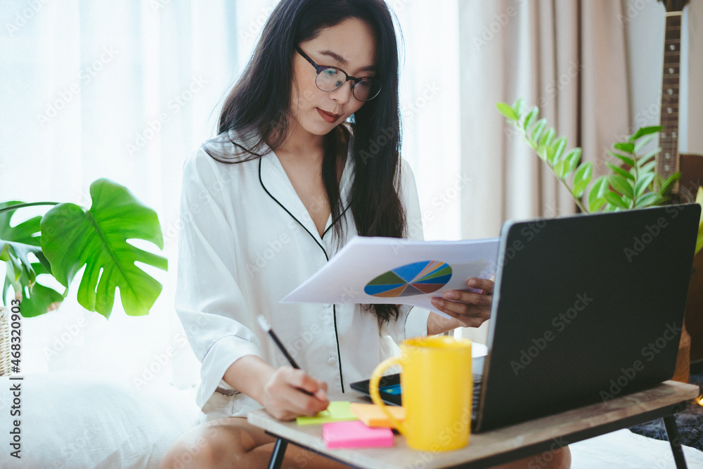 young Asian woman freelance working business work on laptop at home, working from home concept young Asian woman freelance working business work on laptop at home, working from home concept