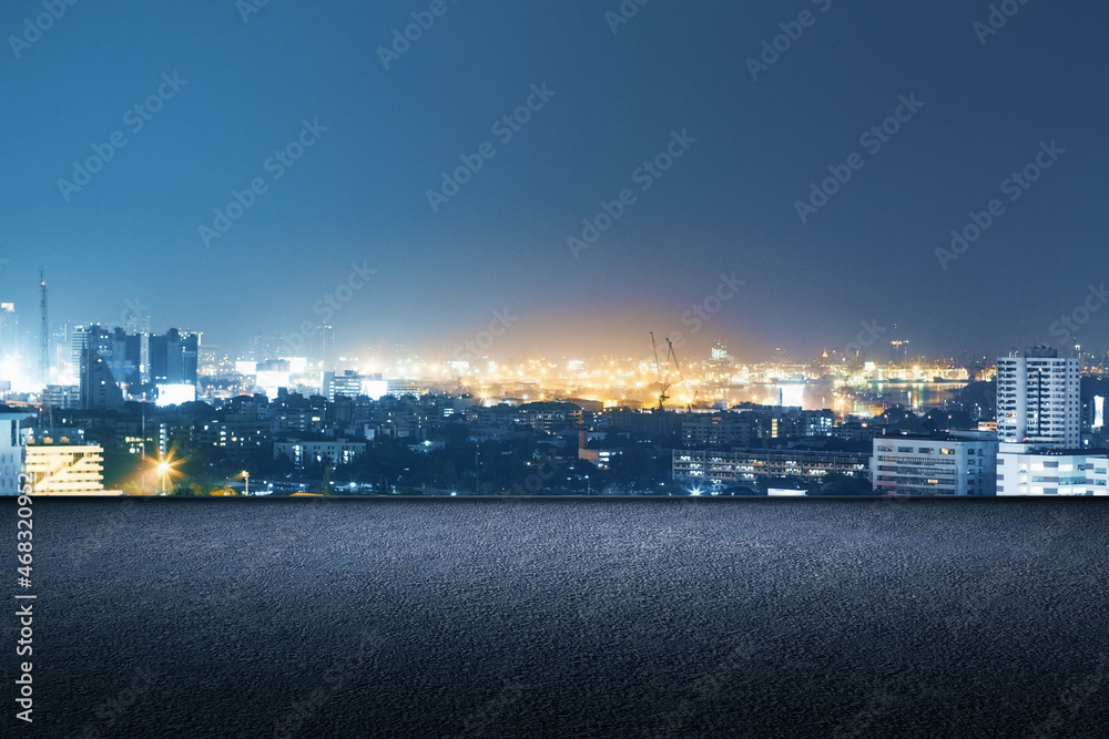 Concrete rooftop with night city view and mock up place for your advertisement. Beautiful texture. Downtown and urban concept.