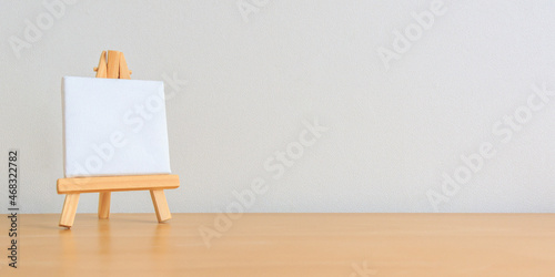 Fototapeta Naklejka Na Ścianę i Meble -  one small blank canvas on tiny wooden easel