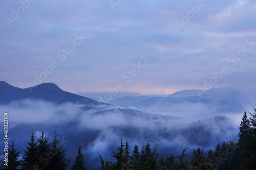 Beautiful view of mountains covered with fog during sunrise