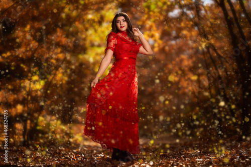 Woman in red dress in the oak forest, full body