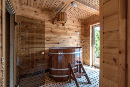 Large standard design classic wooden russian bath sauna interior with hot stones