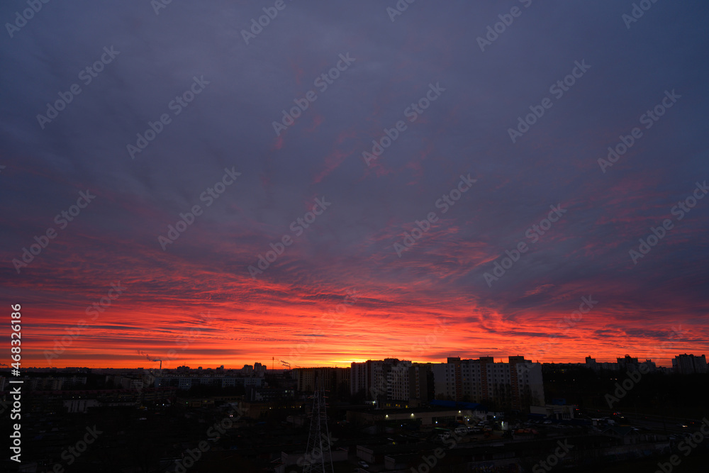 Night clouds over the silhouette of the city at sunrise