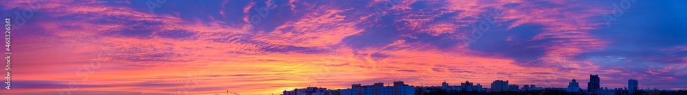 Naklejka premium Photo panorama sky with blue and red sunrise on city silhouette background