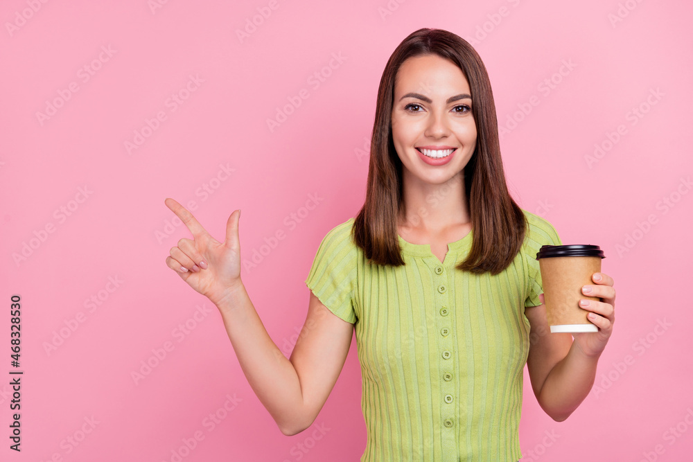 Photo of funny brunette young lady drink coffee wear green t-shirt isolated on pink color background Photo of funny brunette young lady drink coffee wear green t-shirt isolated on pink color background