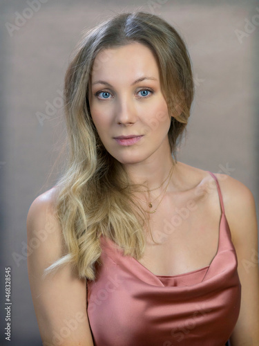 portrait of actress and director Yanna Mazazolina on a gray-blue background