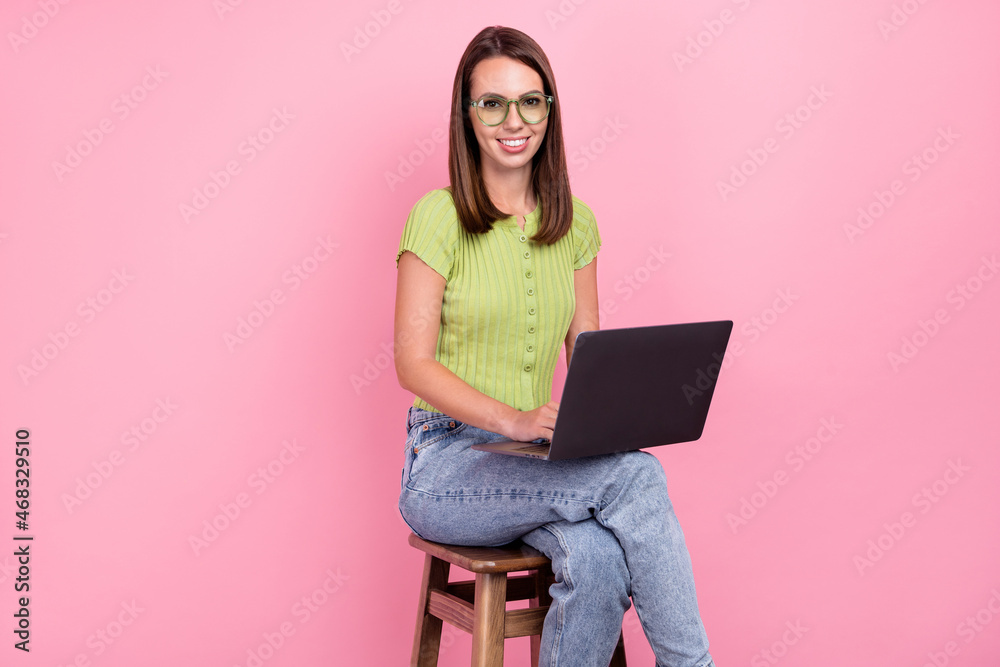 Photo of boss brunette young lady write laptop wear green t-shirt eyewear isolated on pink color background Photo of boss brunette young lady write laptop wear green t-shirt eyewear isolated on pink color background