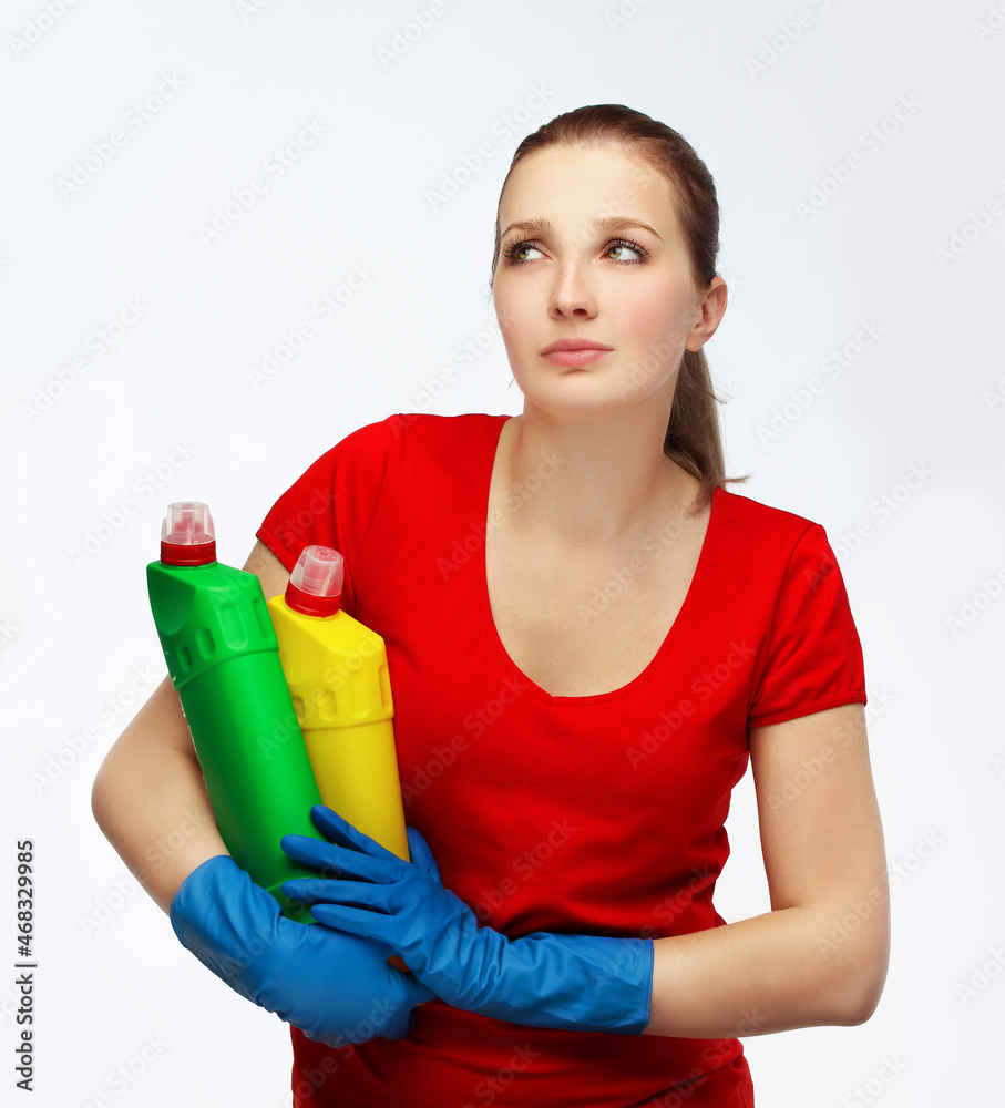 young girl holding detergents and starts cleaning young girl holding detergents and starts cleaning