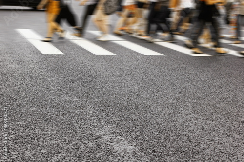 pedestrian crossing of a big city, people crossing the road