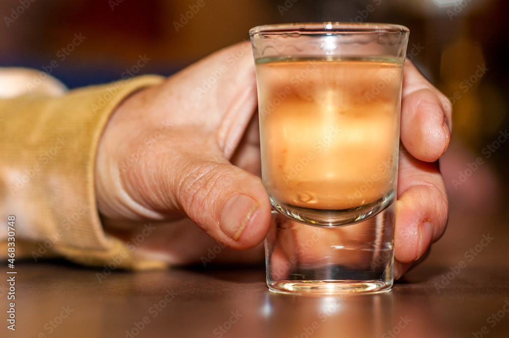Hand with a glass of alcohol Hand with a glass of alcohol