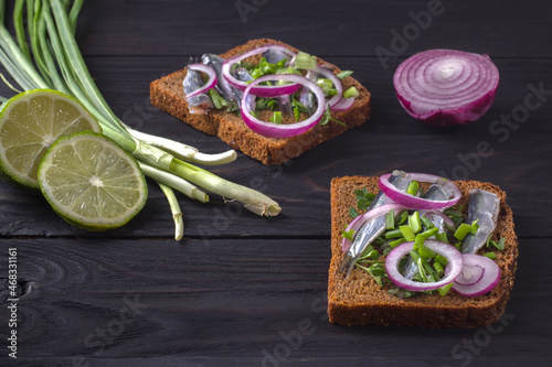 Photos Black bread sandwiches with salted sprat carcasses with onions and parsley