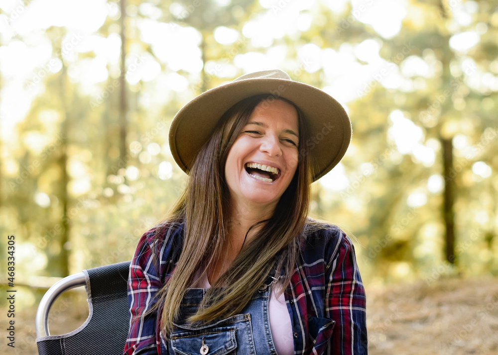 Content traveling woman laughing in woods