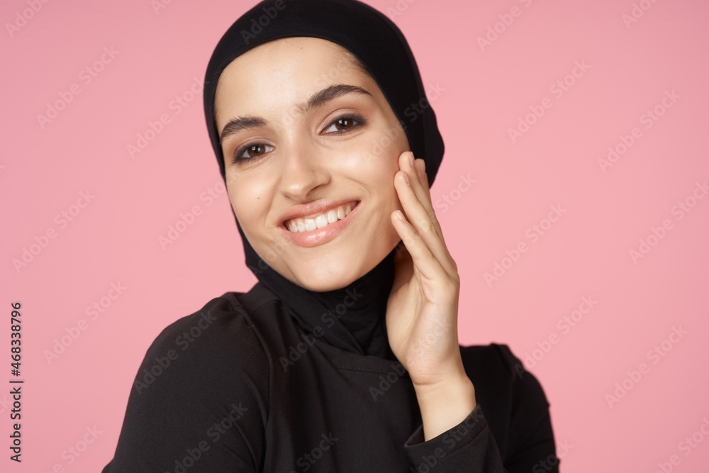 cheerful muslim woman black hijab posing hand gesture pink background