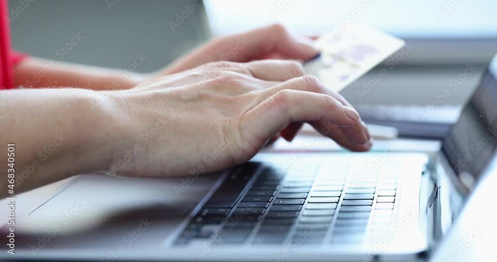 Woman is typing on keyboard and holding credit bank card slow motion 4k movie Woman is typing on keyboard and holding credit bank card slow motion 4k movie