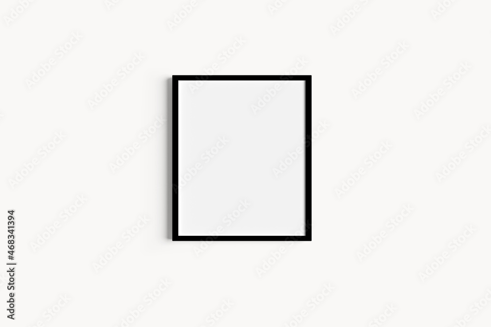 Single black portrait picture frame mockups on white wall Single black portrait picture frame mockups on white wall