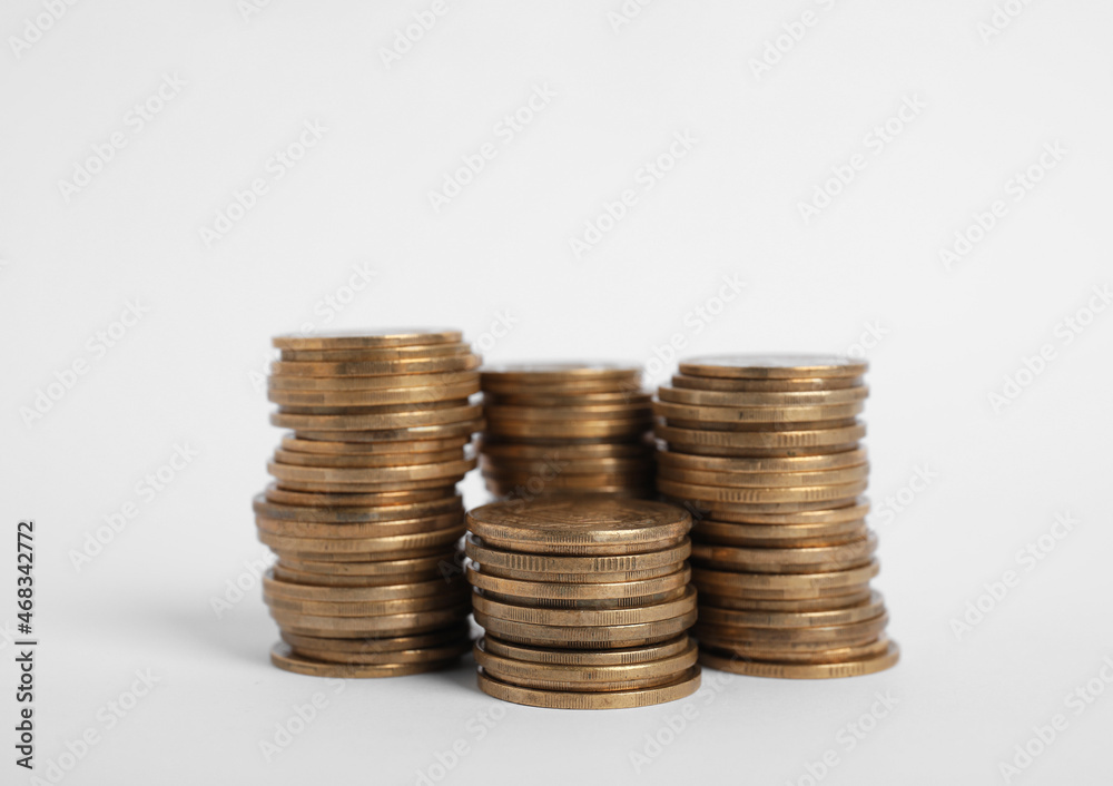 Many Euro coins stacked on white background Many Euro coins stacked on white background