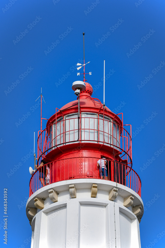 Red lighthouse of ilha do farol, near the city of Faro in Portugal.