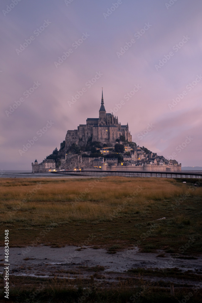 Obraz premium View of famous Mont Saint Michel tidal island at a beautiful sunrise time in Normandy, Northern France