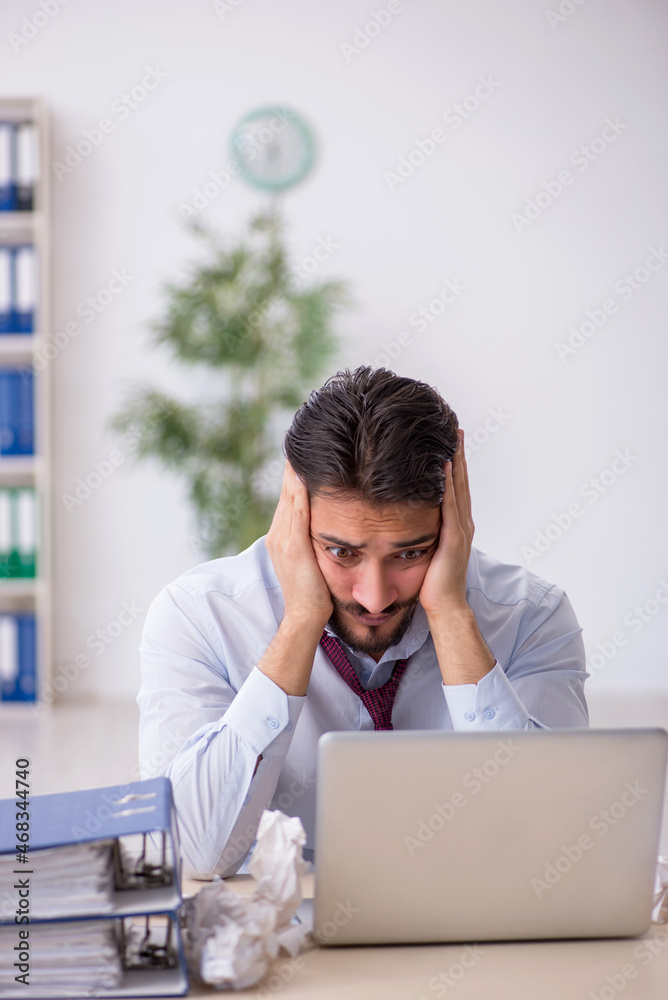 Young male employee in rejected ideas concept Young male employee in rejected ideas concept
