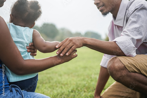 Black Mom, father and daughter having tender moment together outdoor at park city