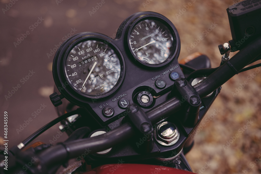 retro motorcycle dashboard on autumn leaves background