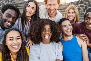 Young diverse people having fun outdoor laughing together - Focus on center african girl face
