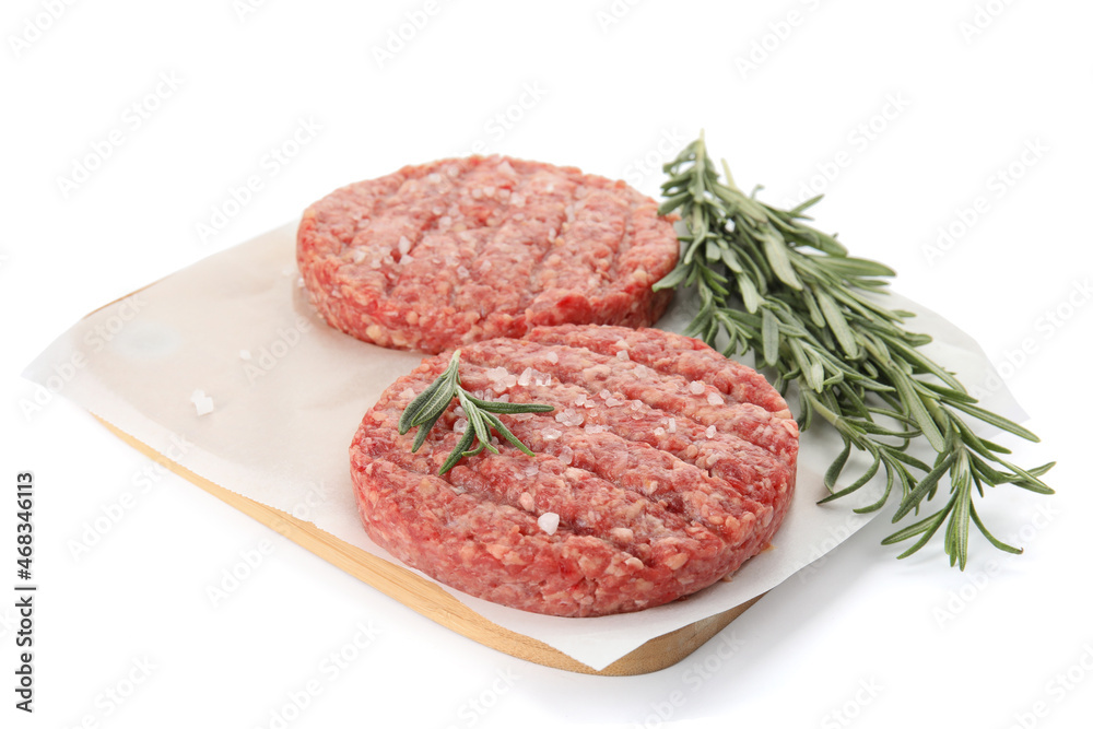 Raw hamburger patties with rosemary and salt on white background Raw hamburger patties with rosemary and salt on white background