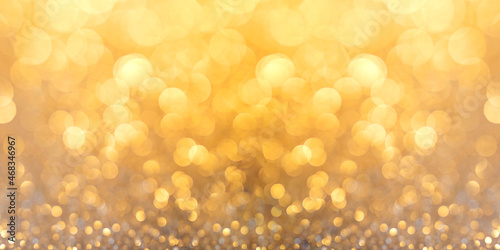 Silver glitter christmas abstract background in golden light