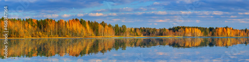 Large-format autumn panorama with a forest and a smooth lake