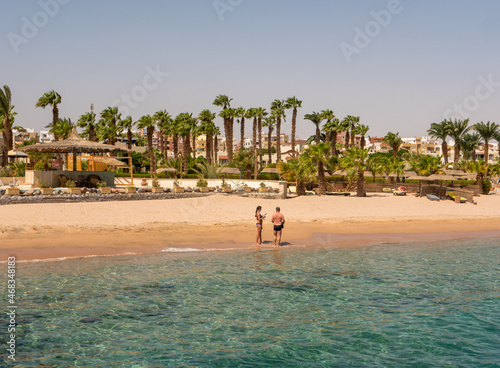 Hurghada, Egypt - September 22, 2021: People stand on the shores of the sandy beach of the Red Sea and get ready for snorkeling.