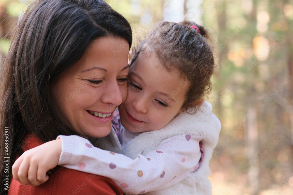 Mother and child in the forest exploring the nature having fun together smiling and laughing, true love emotion Mother and child in the forest exploring the nature having fun together smiling and laughing, true love emotion