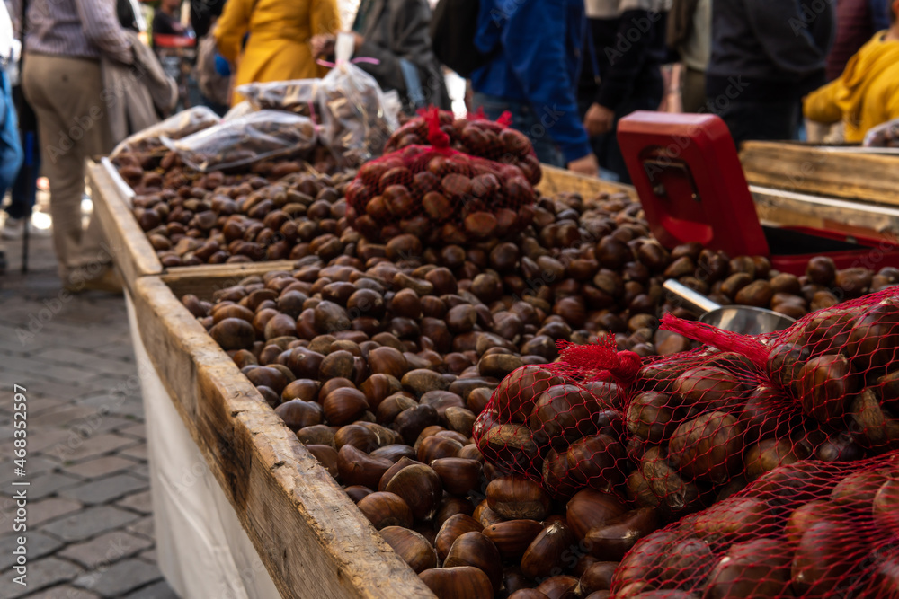 Fototapeta premium Close-up of many chestnuts, displayed at a street market selling local products. Porreres, island of Mallorca, Spain