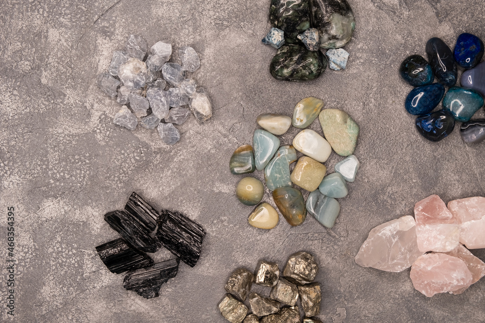 Close up of different kinds of stones in a variety of colours. Different shapes sea rock pebbles. Colorful rocks. Semi precious gem stones collection. Texture of different types of stones. Gemstones Close up of different kinds of stones in a variety of colours. Different shapes sea rock pebbles. Colorful rocks. Semi precious gem stones collection. Texture of different types of stones. Gemstones