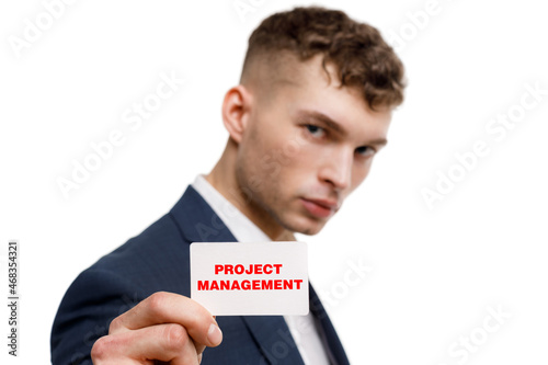 A businessman shows an inscription: PROJECT MANAGEMENT