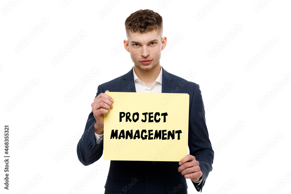 A businessman shows an inscription: PROJECT MANAGEMENT A businessman shows an inscription: PROJECT MANAGEMENT