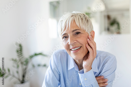 Senior woman looking at camera. Successful mature business woman. Happy old professor with gray hair.