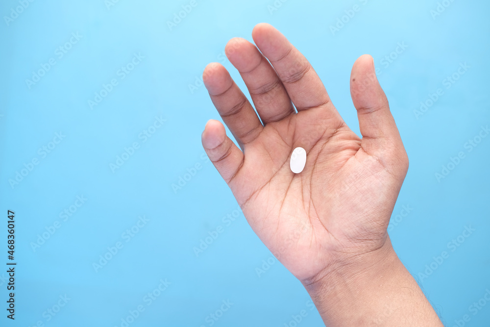 Close up of man hand holding pills with copy space Close up of man hand holding pills with copy space