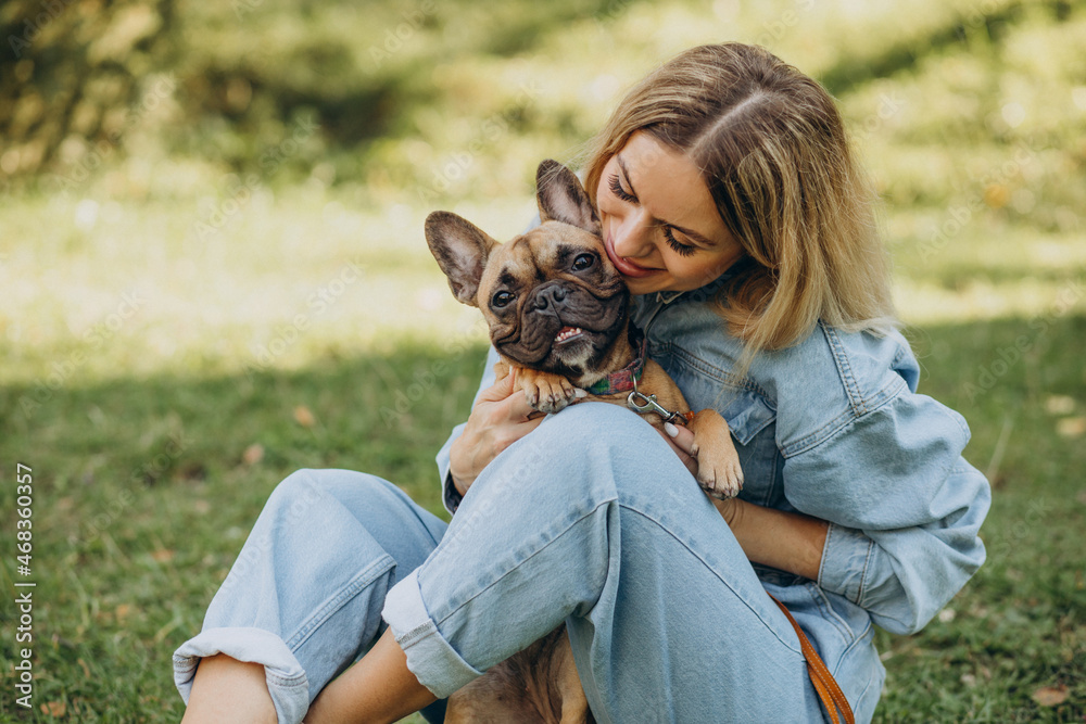 Young woman with her pet french bulldog in park Young woman with her pet french bulldog in park