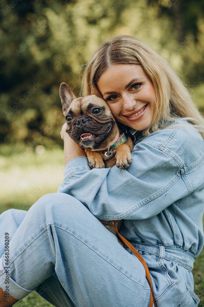 Young woman with her pet french bulldog in park Young woman with her pet french bulldog in park