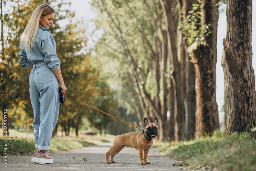 Young woman with her pet french bulldog in park Young woman with her pet french bulldog in park