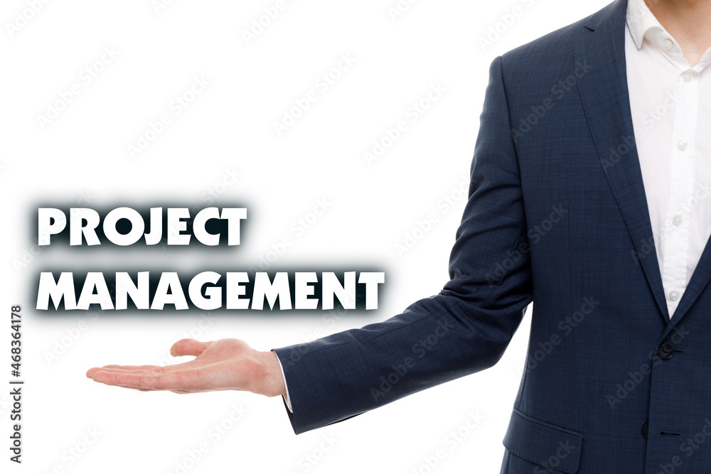 A businessman shows an inscription: PROJECT MANAGEMENT A businessman shows an inscription: PROJECT MANAGEMENT
