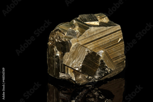 Macro mineral stone Pyrite on a black background