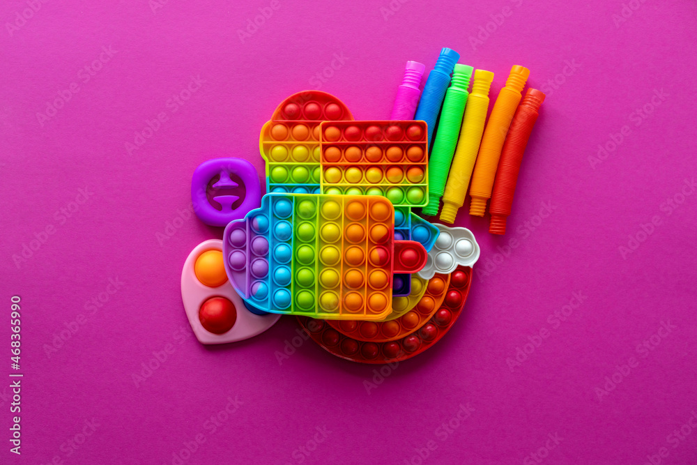 Antistress toys education concept. Popular toy among children. Pink background.