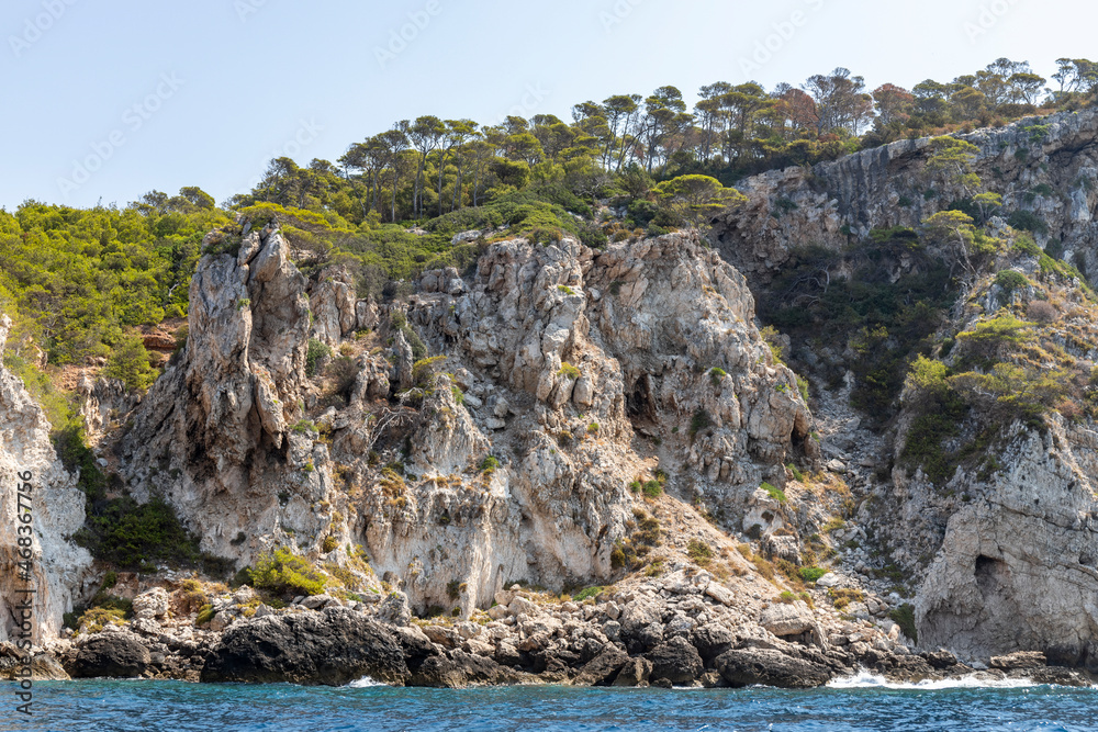 Limestone rocks, vegetation and the coast of the island of San Domino of the archipelago of the Tremiti Islands in Puglia, Italy.