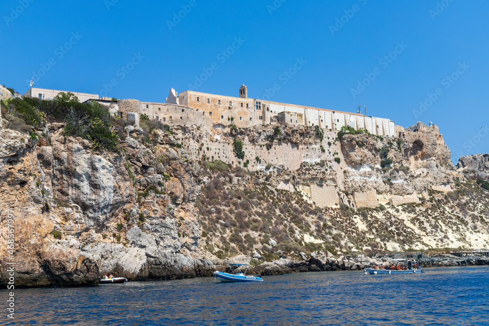 Island of San Nicola in the archipelago of the Tremiti Islands and tourists by boat. Rock with stretches of cliff on the island. Island of San Nicola in the archipelago of the Tremiti Islands and tourists by boat. Rock with stretches of cliff on the island.