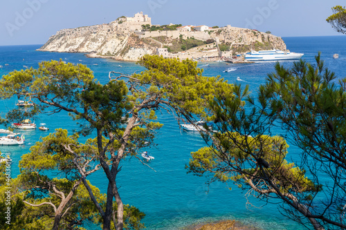 Breathtaking landscape of the Tremiti Islands with the crystal clear sea, vegetation and the island of San Nicola in the background of the archipelago of the Tremiti Islands, Puglia, Italy.