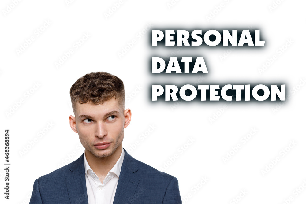 A businessman shows an inscription: PERSONAL DATA PROTECTION A businessman shows an inscription: PERSONAL DATA PROTECTION