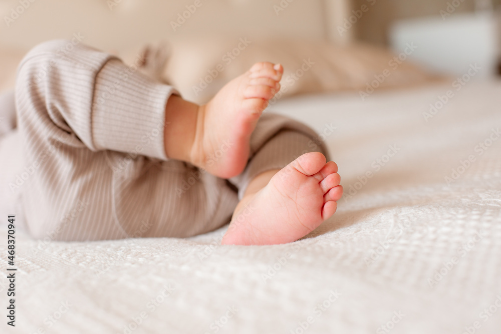 legs of a newborn baby in bedroom at home legs of a newborn baby in bedroom at home